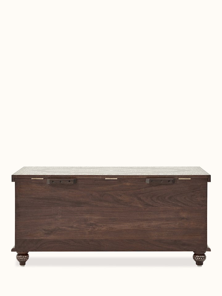 Full view of the bone inlay trunk in a room setting, illustrating its stylish design and practical use