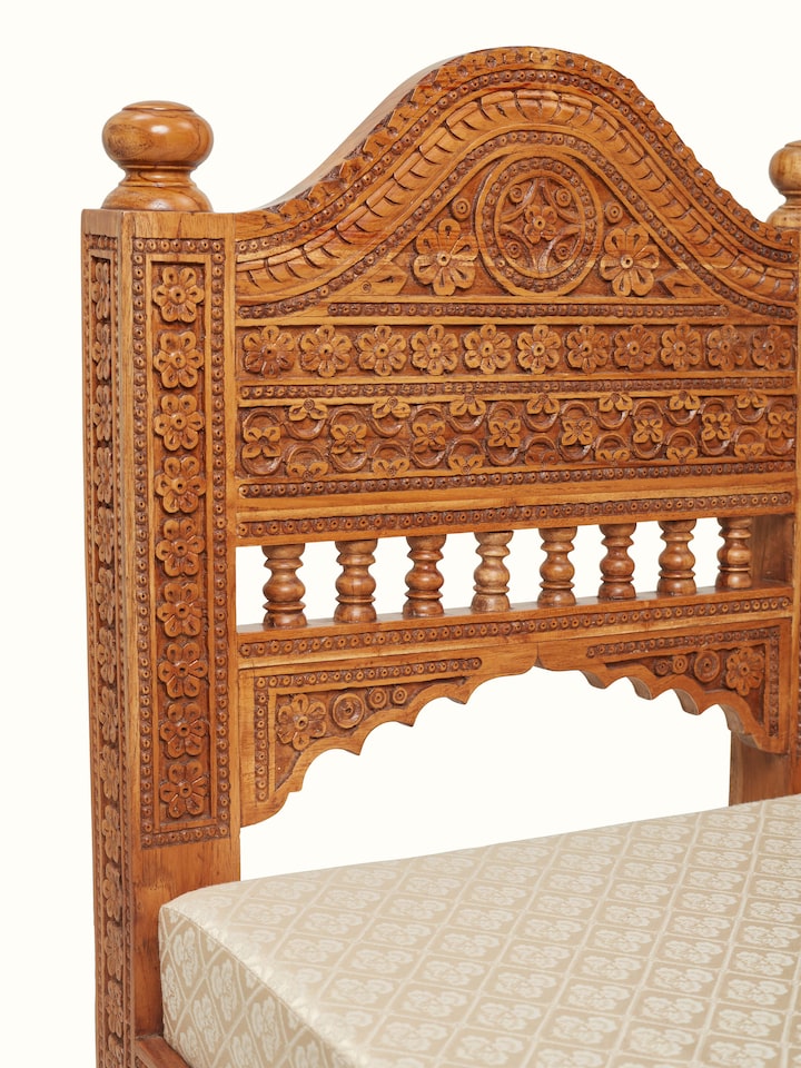 Detailed view of the sofa’s upholstery and carved wooden legs, highlighting the craftsmanship and design
