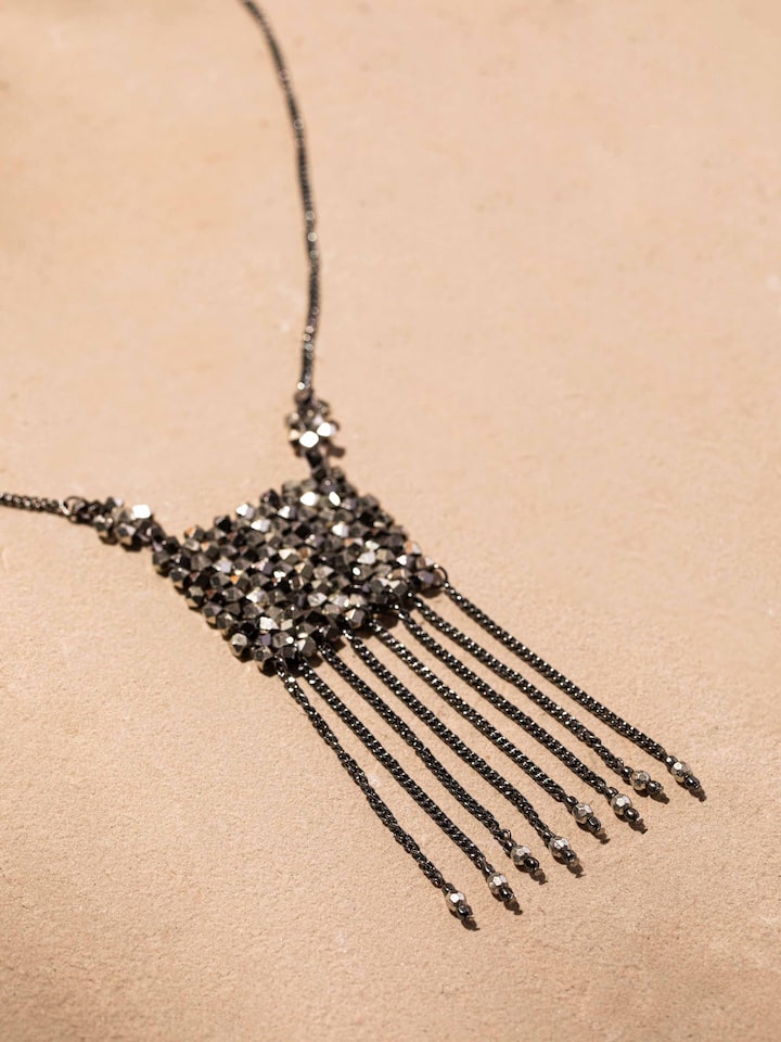 Detailed close-up of handcrafted long necklace highlighting the intricate work and materials