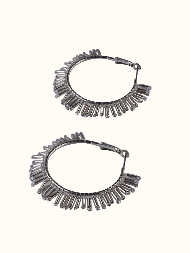 Detailed view of handcrafted hoop earrings focusing on their artistic design and fine craftsmanship.
