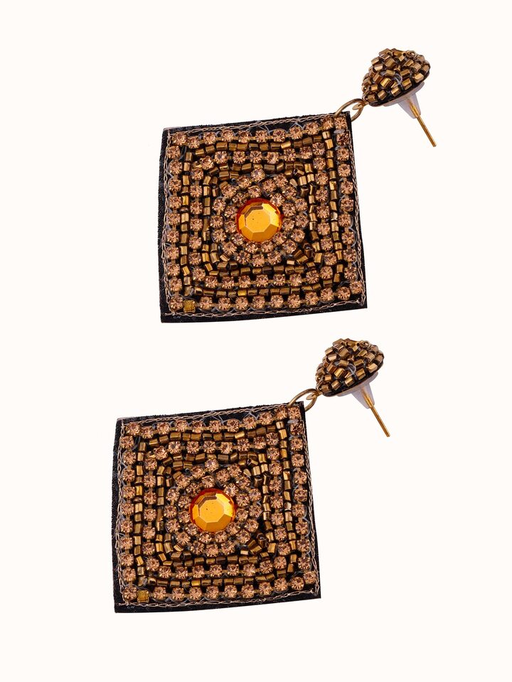 Angled view of Handcrafted Drop Earrings showcasing elegant design and detailed work.