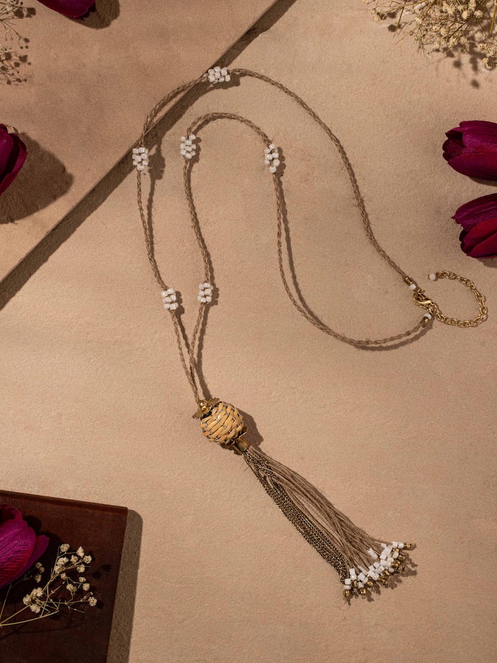 Close-up of handcrafted long necklace emphasizing intricate bead patterns