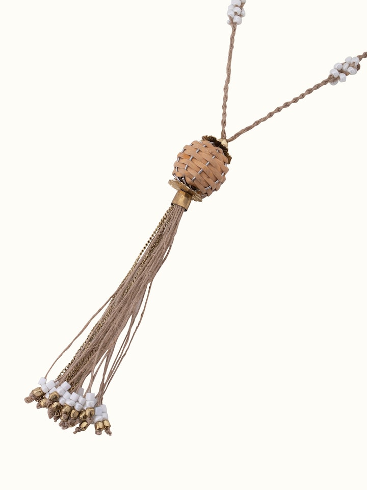 Angled view of handcrafted long necklace highlighting its artistic elements