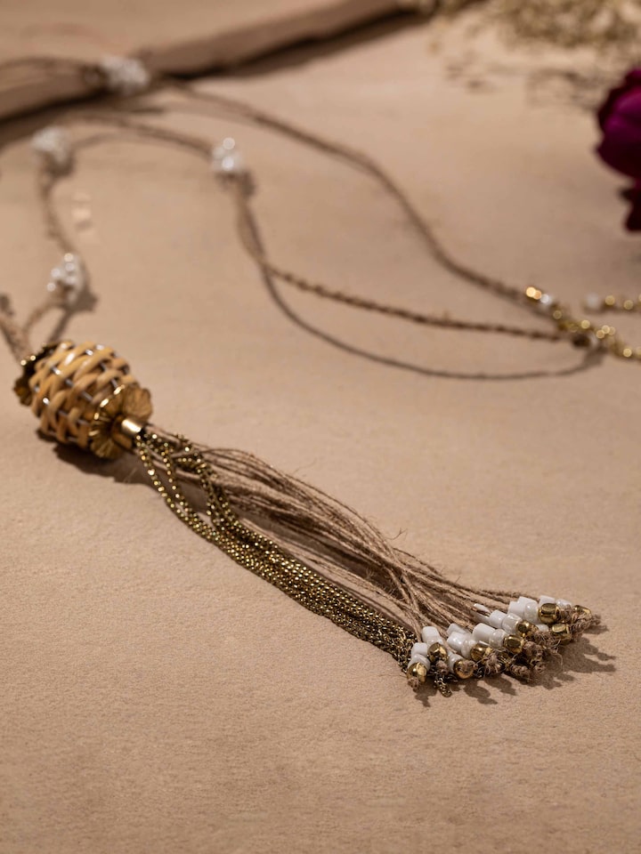 Detailed shot of handcrafted long necklace with a focus on its elaborate design