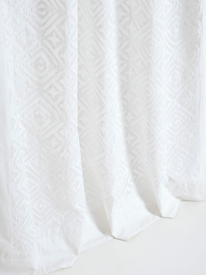 Close-up of Mandana White Trellis sheer curtain showing the cotton fabric texture and applique details