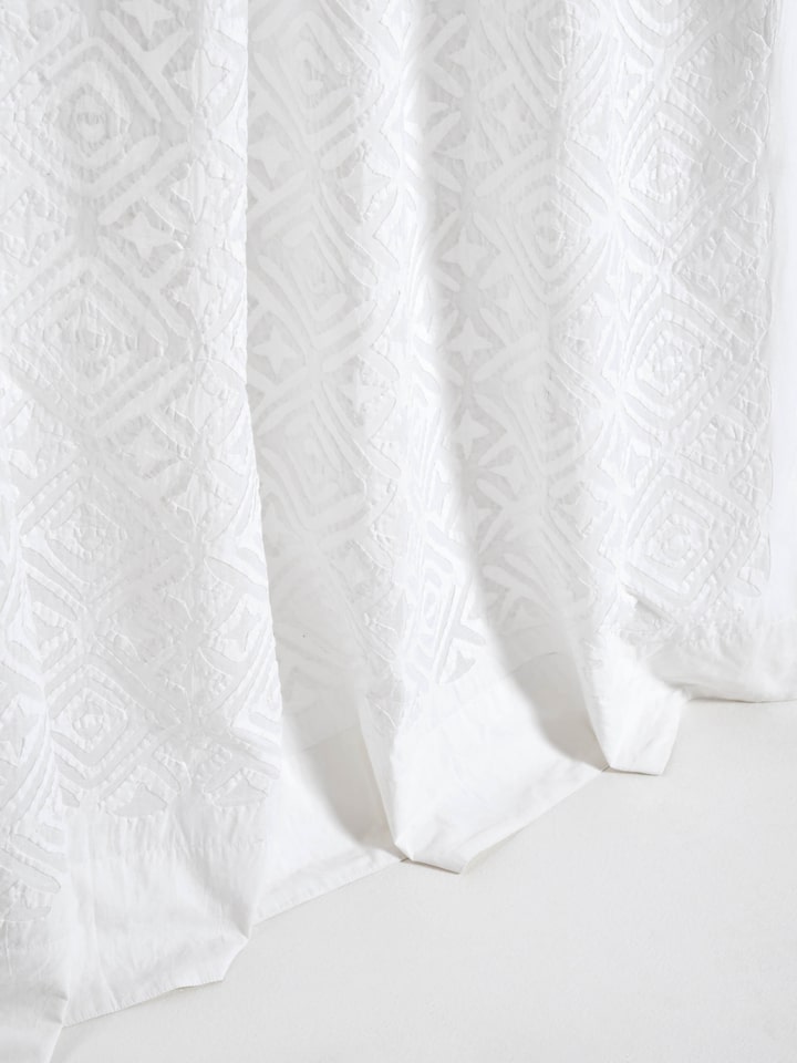 Detail shot of Mandana white trellis allover cotton applique sheer curtain showing the quality of the applique work