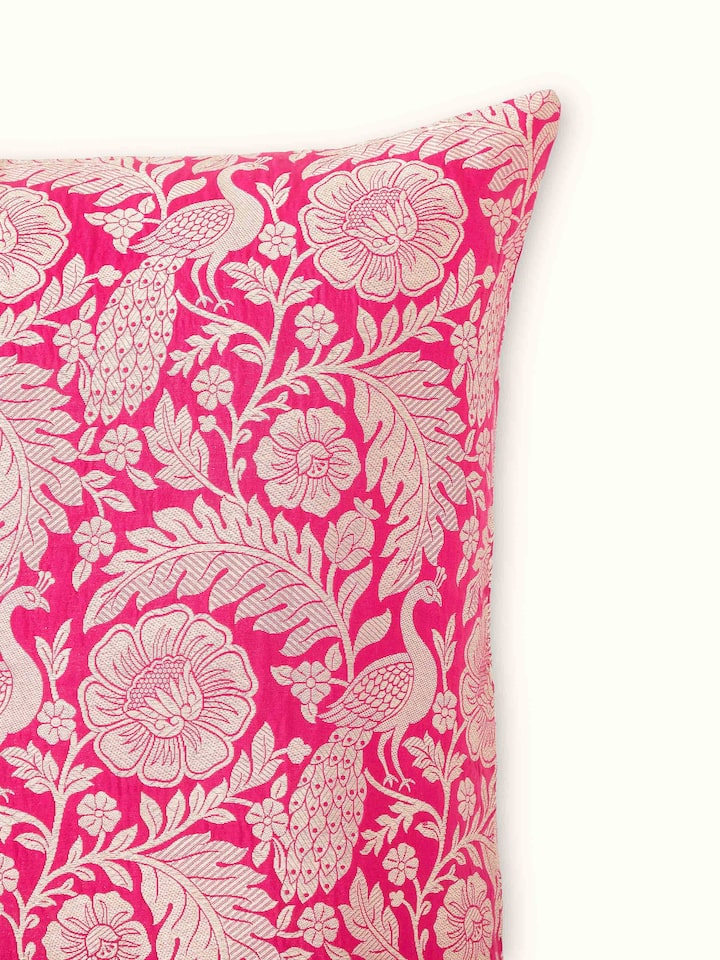 Side view of Avasa raspberry floral silk brocade Banarasi handloom cushion cover capturing the texture and detailing of the fabric.