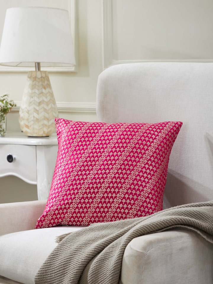 Lifestyle image of Avasa handloom silk cushion styled in an elegant interior setting