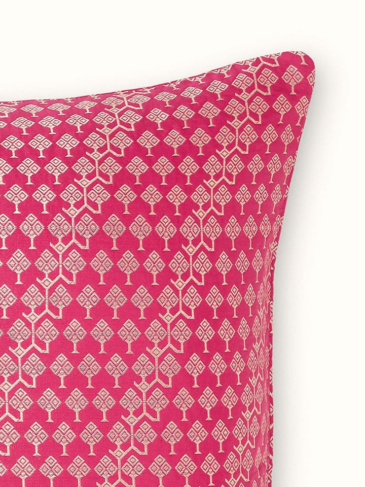 Detail view of handloom brocade design in metallic threads over pink silk base