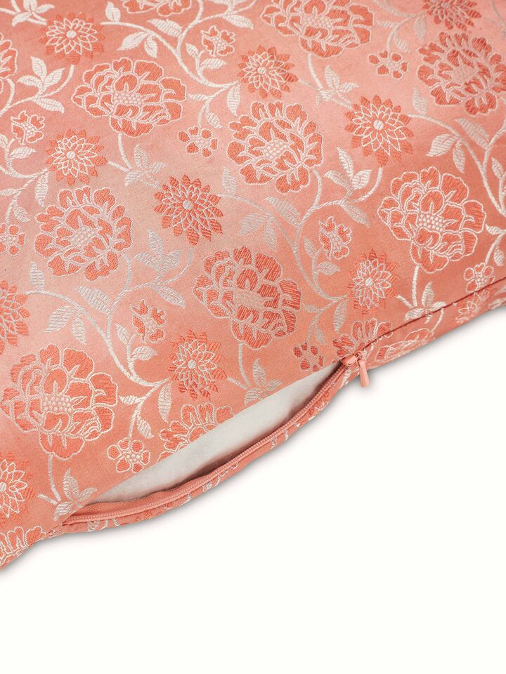 Close-up of Jangala peach jaal silk brocade Banarasi handloom cushion cover focusing on the detailed embroidery and fabric.
