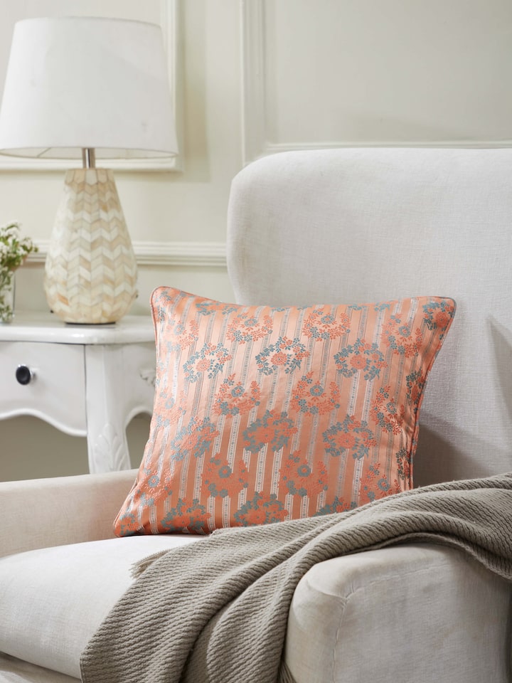 Peach Banarasi brocade cushion cover from Matsya collection styled in modern living room