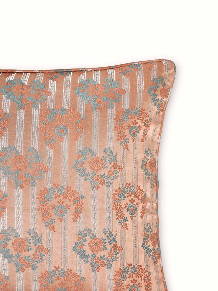 Zoomed-in view showing intricate craftsmanship on peach Banarasi brocade cushion cover