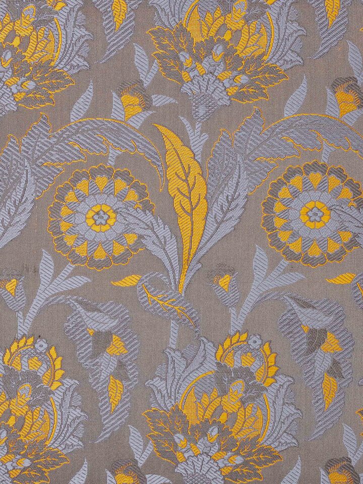 Close-up of fabric texture and motif detail on grey Banarasi silk cushion cover