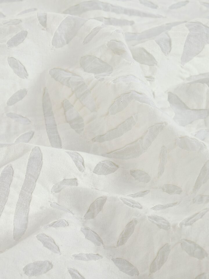 Detailed view of Ekam white trellis cotton appliqué embroidered table cover (4 seater) highlighting the fine embroidery and texture.