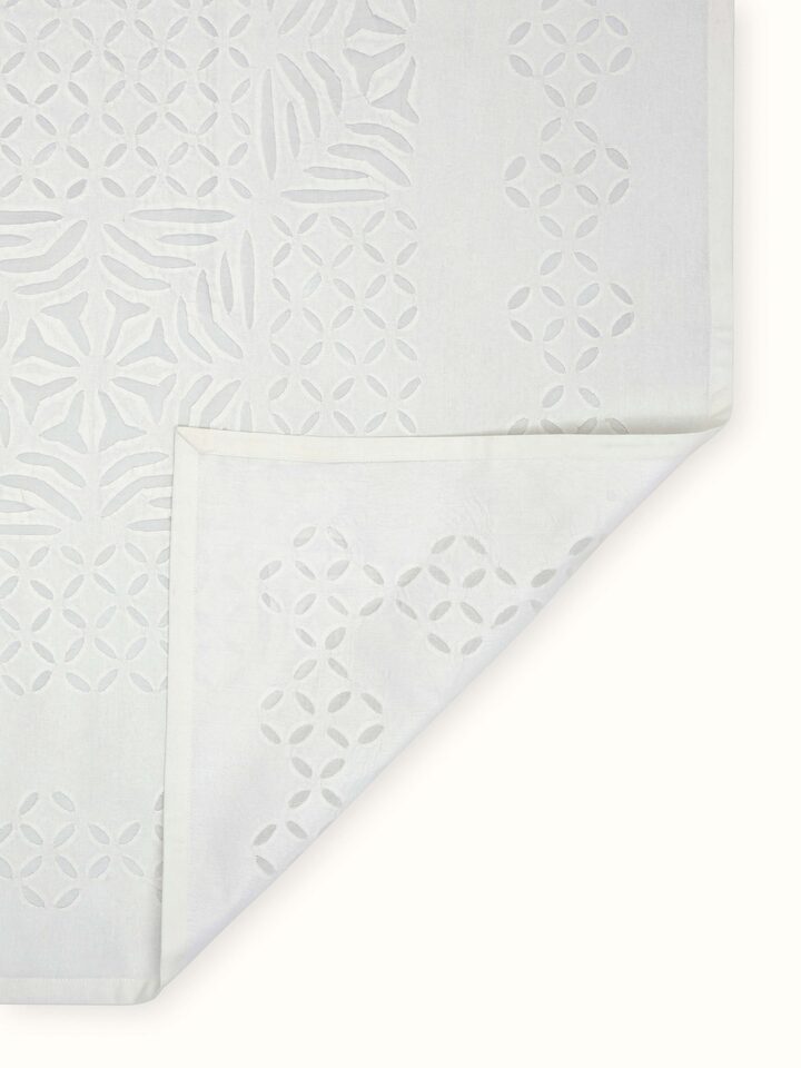 Ekam white trellis cotton appliqué embroidered table cover (4 seater) displayed on a table showing its full pattern and design.