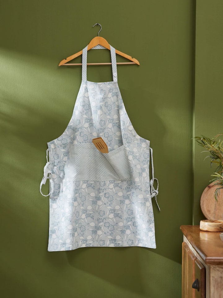 Detailed close-up of Anika light blue floral cotton Sanganeri block printed apron highlighting the block print details and fabric texture.
