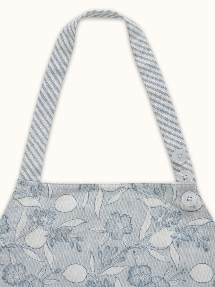 Close-up view of Anika light blue floral cotton Sanganeri block printed apron showcasing the intricate block print design.