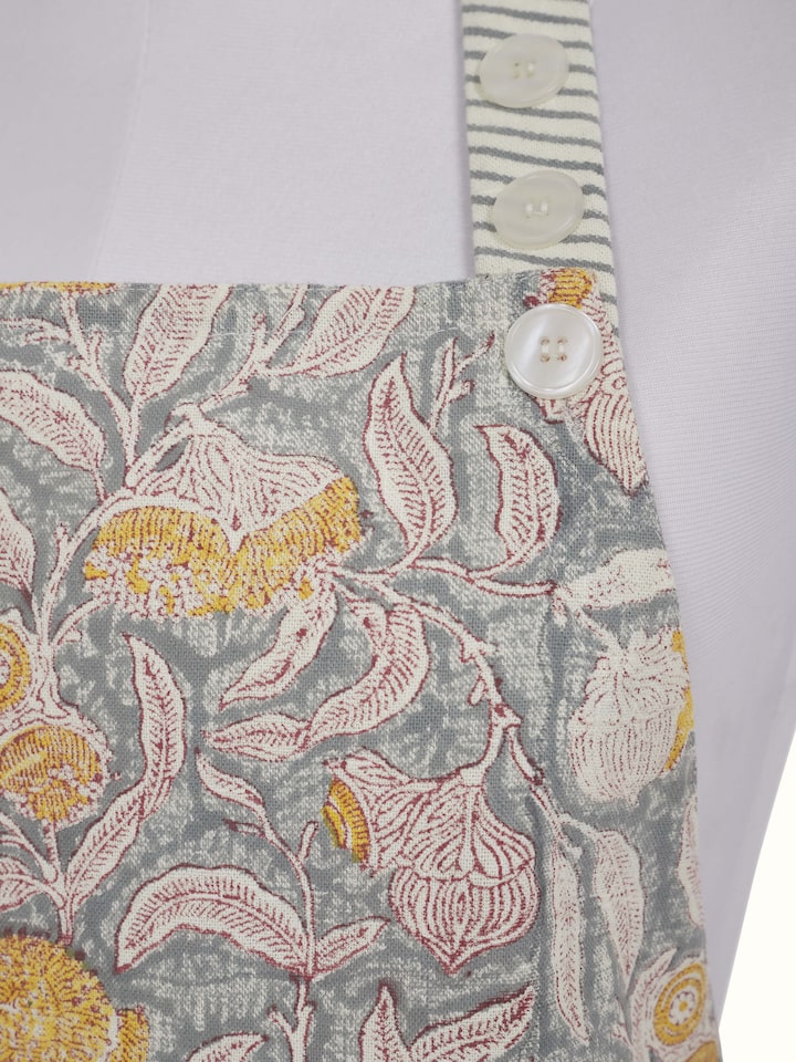 Close-up view of grey floral cotton Sanganeri block printed apron highlighting the fabric texture and print details.