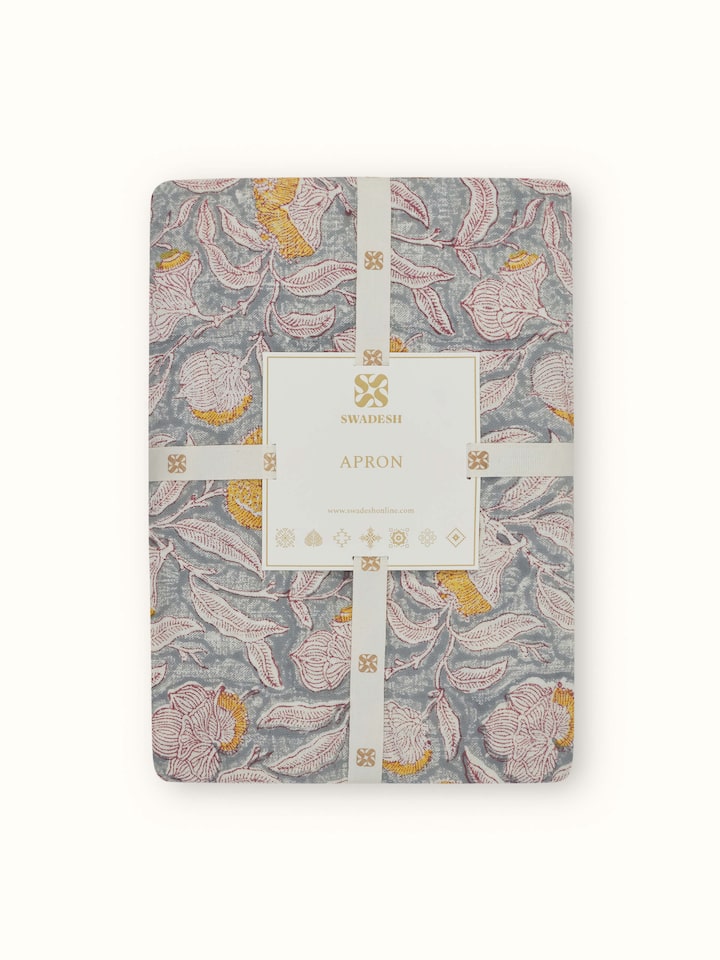 Full view of grey floral cotton Sanganeri block printed apron showing the design and adjustable straps.