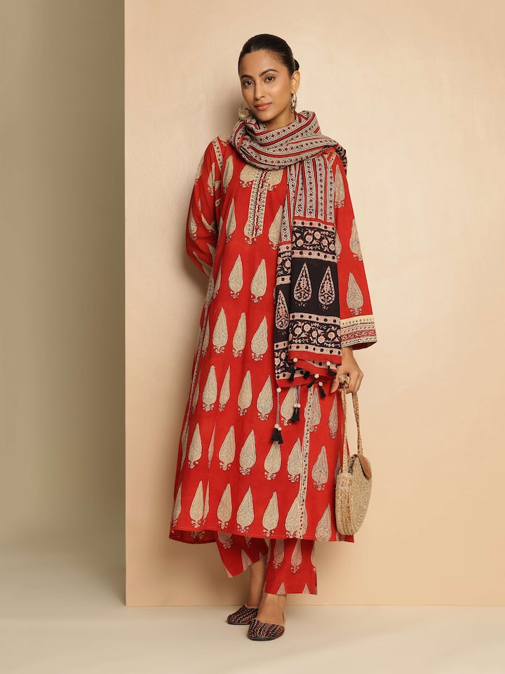 Lifestyle view of red Bagru kurta styled with white pants.
