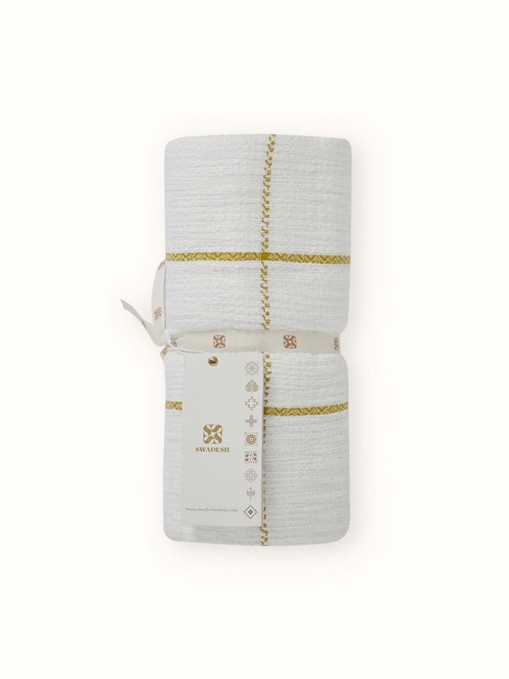 Close-up of Adhima Ochre Throw, highlighting the handloom twill pattern and soft cotton fabric.