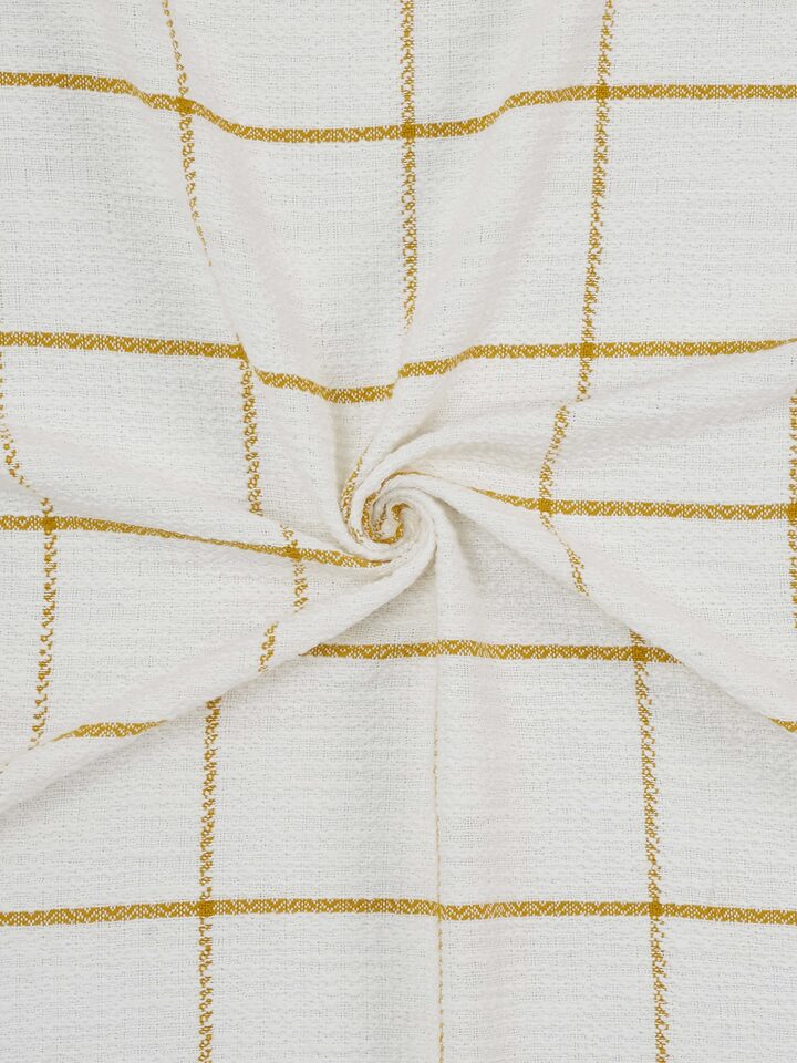 Angled view of Adhima Cotton Throw in ochre, showing layered texture and artisan weave.