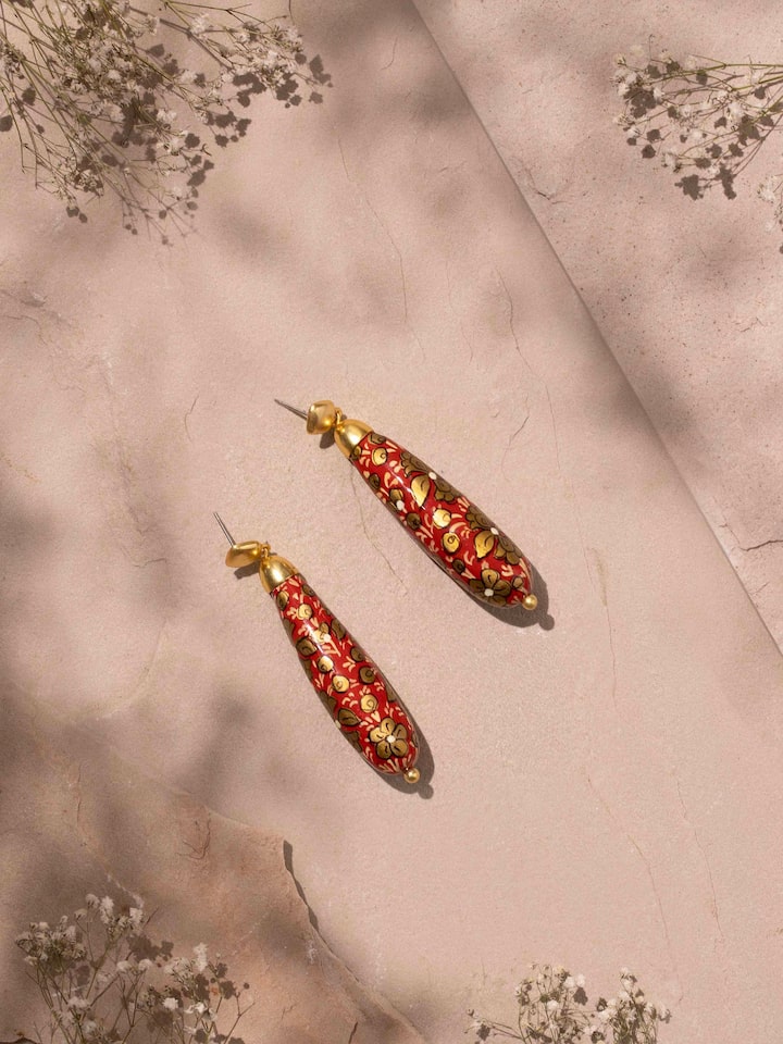 Close-up view of Papier-mâché Drop Earrings emphasizing the vibrant colors and intricate patterns.