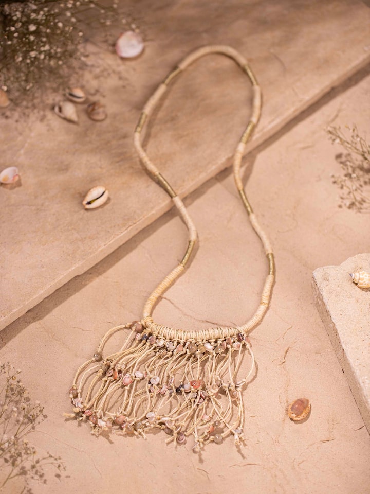 Close-up of Cowrie Shell Drop Earrings showcasing detailed shell design and craftsmanship.
