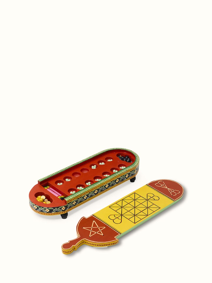 Side view of Ganjifa cedar wood 6-in-1 board game in red showcasing its compact design