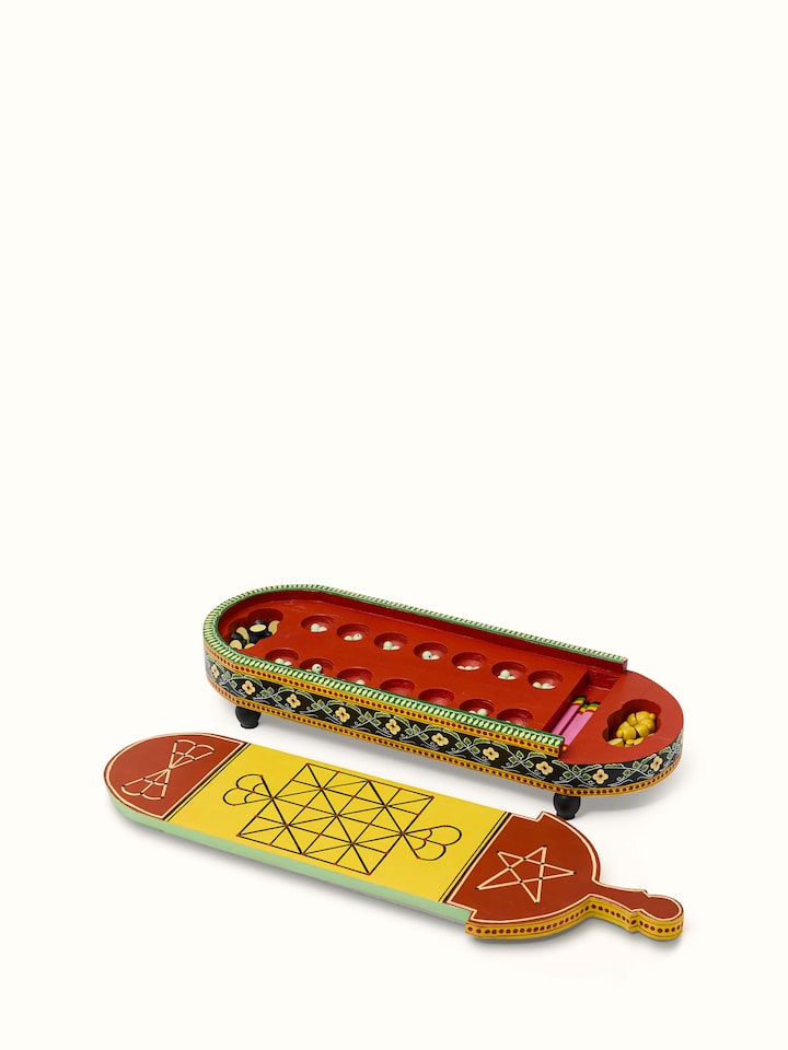 Top view of Ganjifa cedar wood 6-in-1 board game in red displaying the variety of game pieces