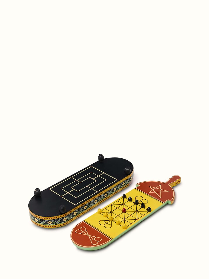 Close-up of Ganjifa cedar wood 6-in-1 board game in red focusing on detailed craftsmanship