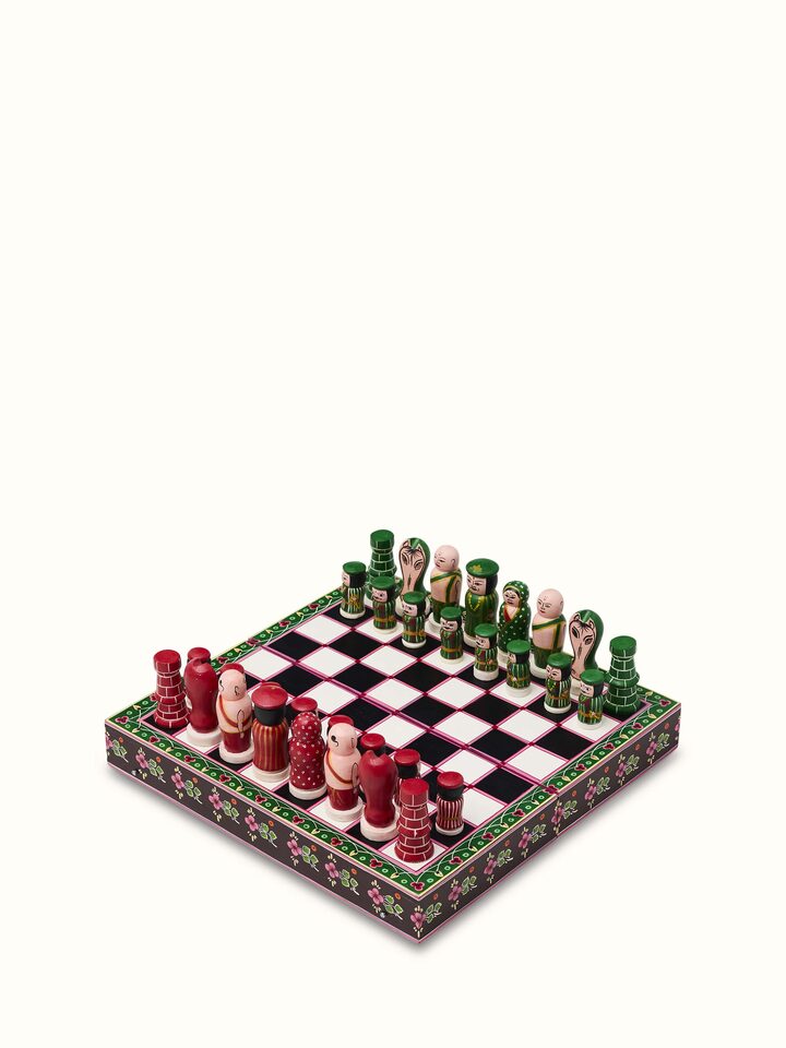 Close-up view of Ganjifa Cedar Wood Chess Set revealing detailed carving on the chess pieces.