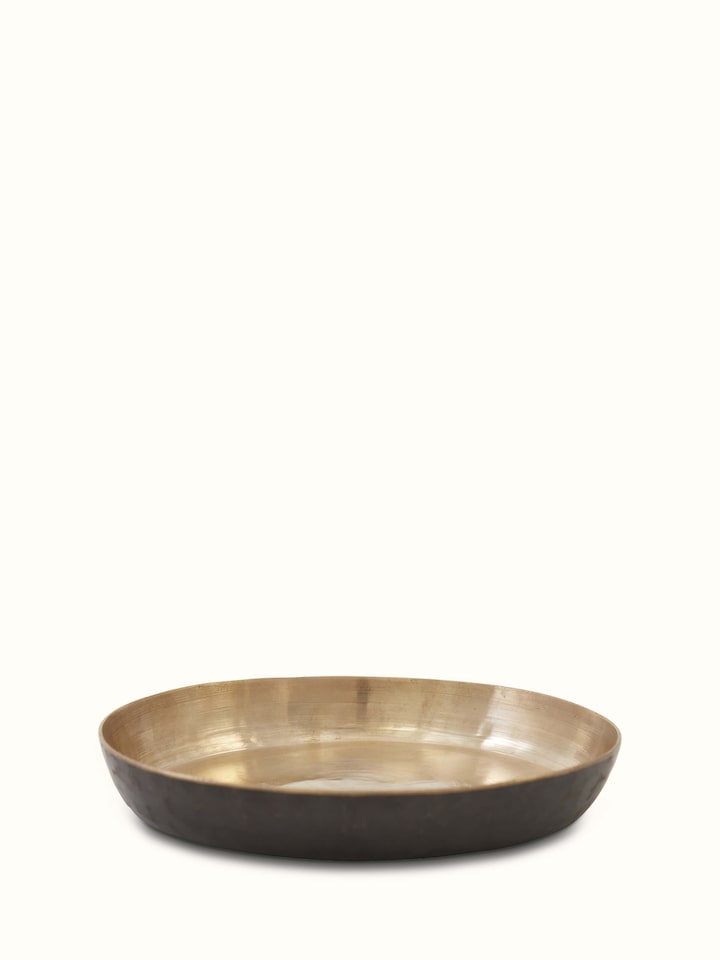 Front view of bell metal salad plate, showcasing its shiny surface and intricate design
