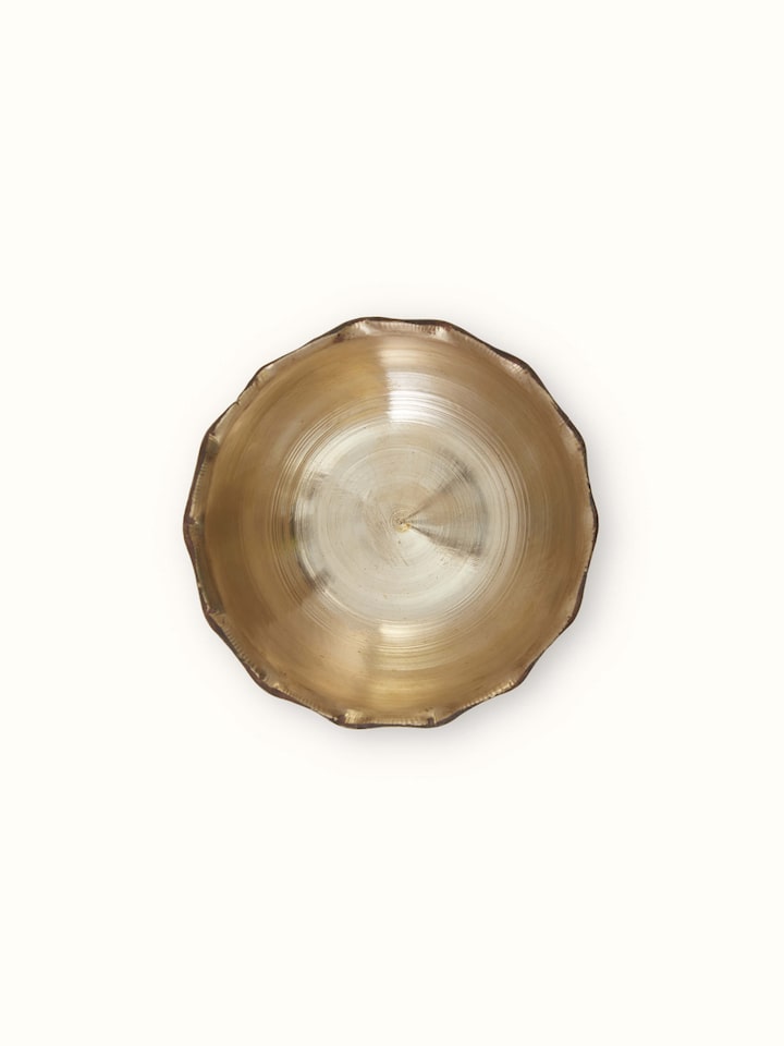 Angled view of Bell metal pinchha dinner bowl highlighting details