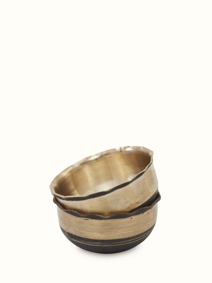 Close-up view of Bell metal pinchha dinner bowl focusing on traditional patterns