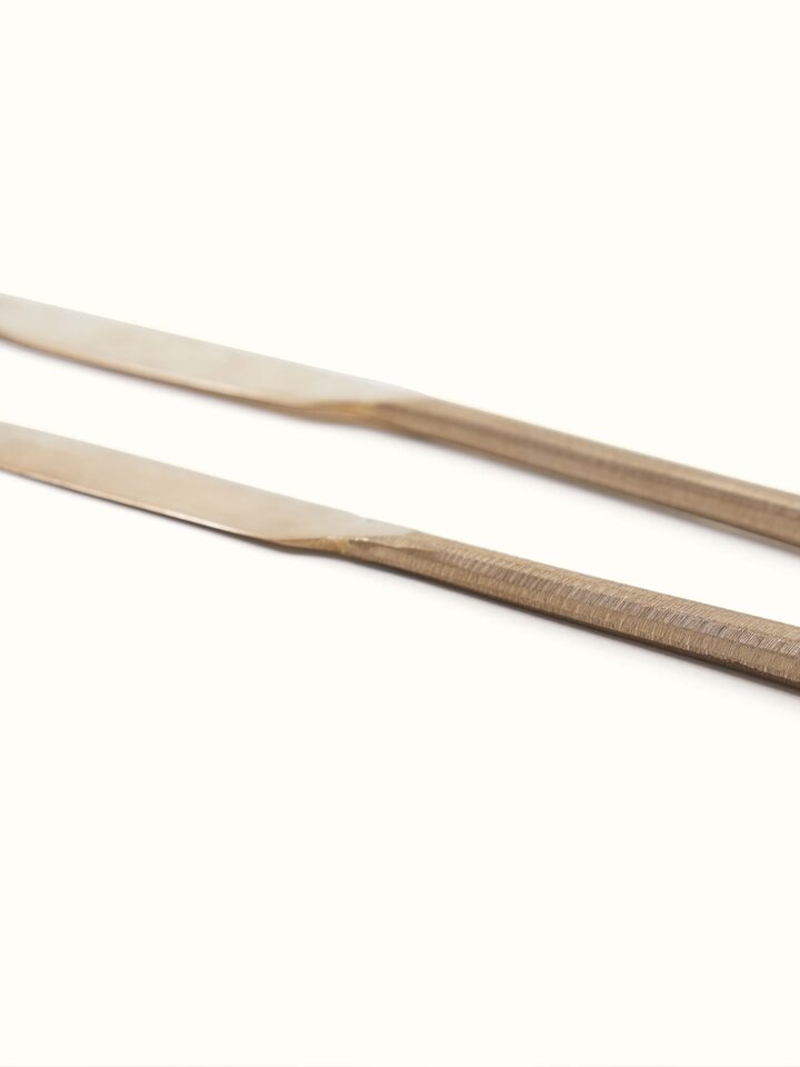 Side view of bell metal dinner knife featuring detailed engravings