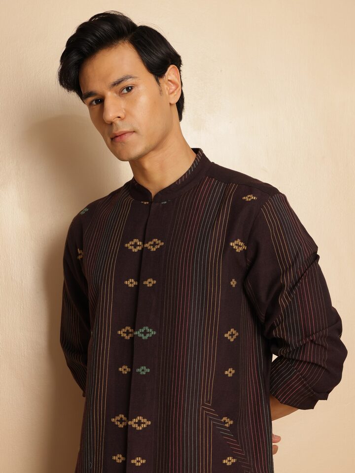 Angled lifestyle shot highlighting woven detailing and side slit design of the kurta