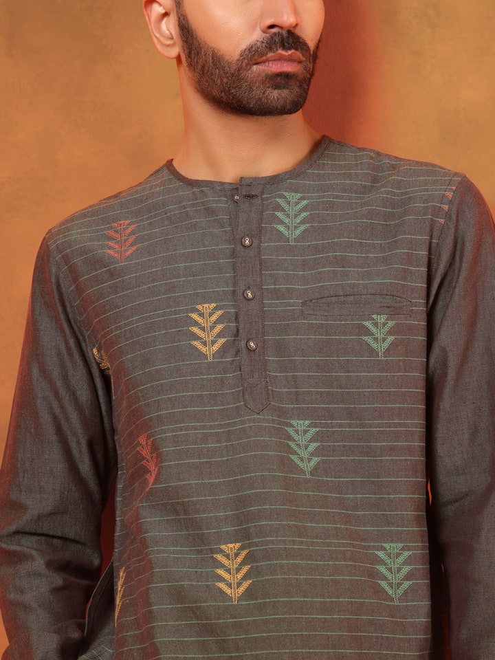 Angled view of extra-weft weave short kurta in brown, highlighting textured detail.