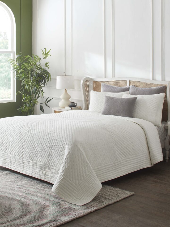 Close-up of the textured stripes on the Kapasa off-white cotton handloom bedspread