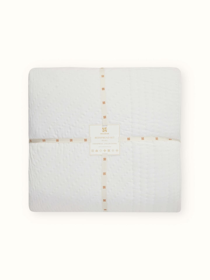 Side view of the Kapasa off-white textured stripe cotton bedspread displaying the handloom craftsmanship