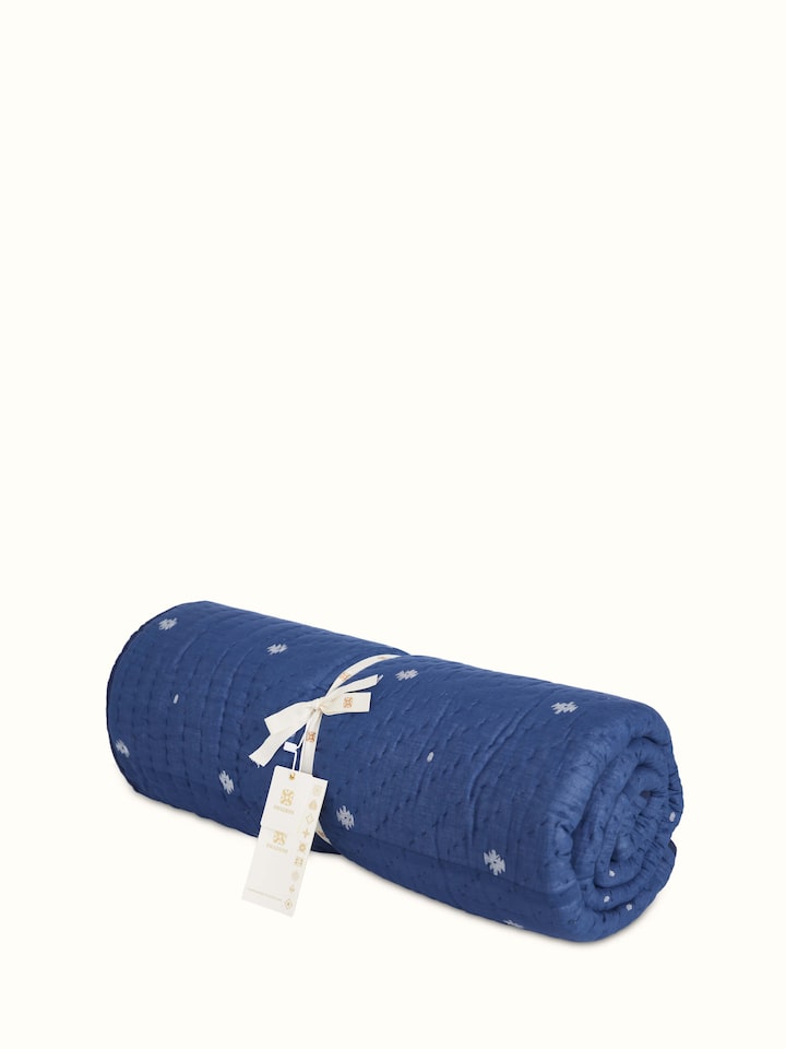 Close-up of Kalpanama Indigo Woven Buti Cotton Single Quilt, focusing on the texture and detail of the woven design.