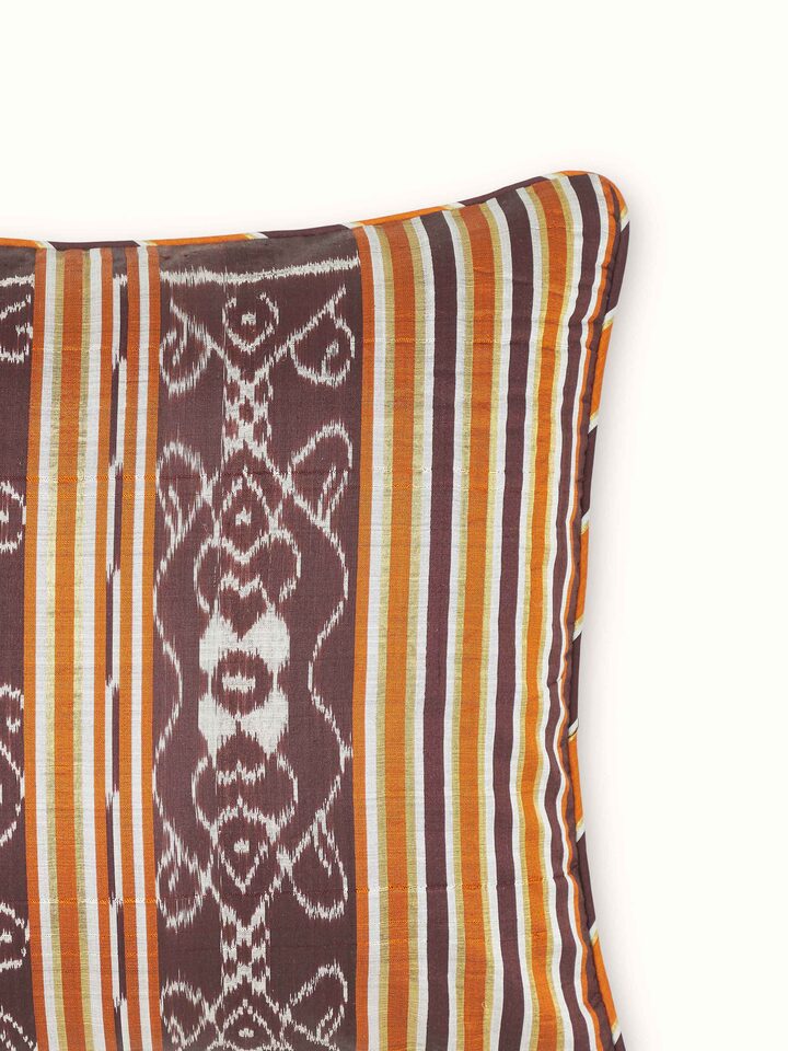 Detailed close-up of Sanchaya coffee stripe silk lumbar cushion cover, showcasing the intricate Odisha handloom Ikat weaving.