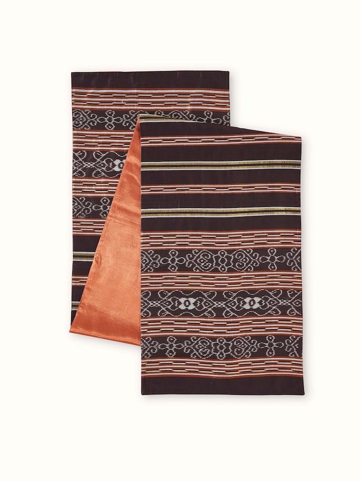 An angled view showing the coffee-striped design of the Sanchaya Odisha Handloom Bed Runner, emphasizing the luxurious sheen and handcrafted finish.