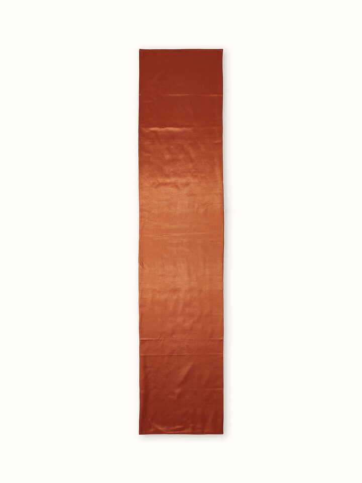 A rear view of the Swadesh Sanchaya Bed Runner in silk, capturing the fine handwoven quality and subtle details of the Ikat craftsmanship.