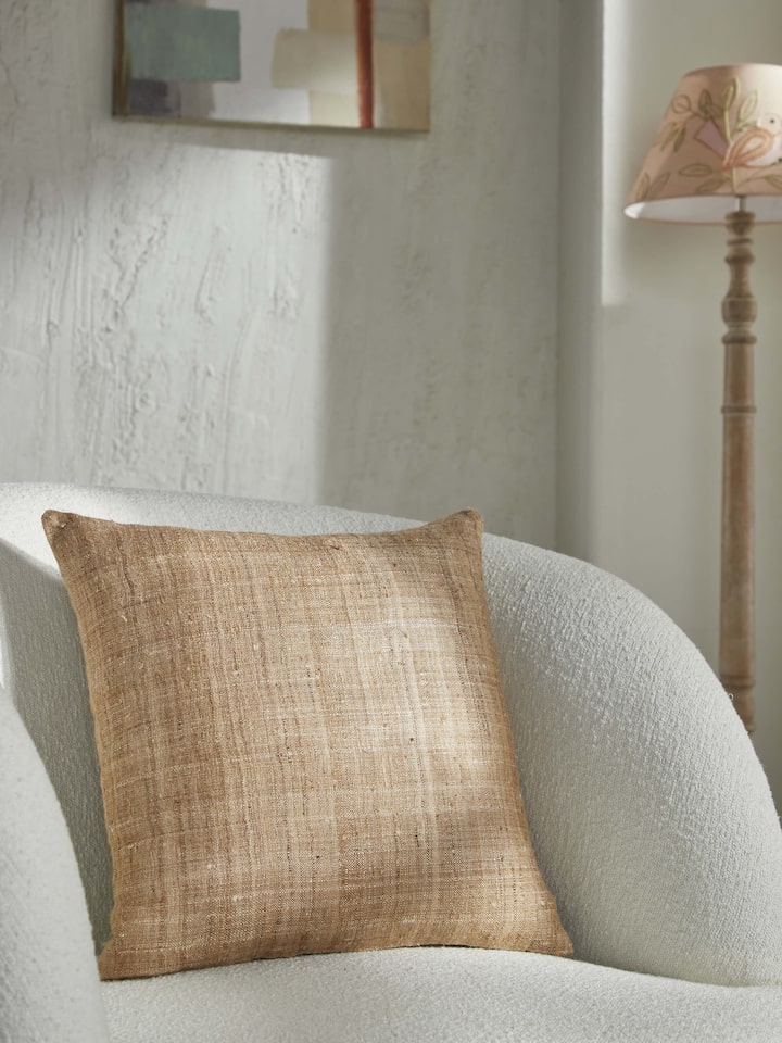Close-up of Ujjal brown Dharana silk slub handloom cushion cover highlighting the silk slub texture.