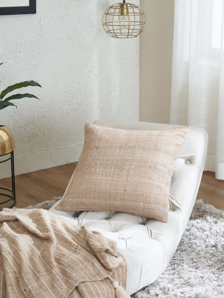 Side view of Ujjal light brown dharana silk slub handloom cushion cover highlighting the intricate weave and design
