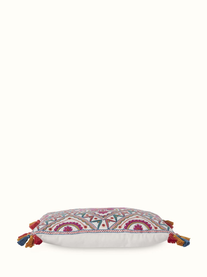 Angled view of cushion showing hand embroidery texture and rich multicolor threads.