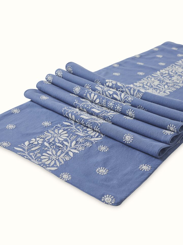 Detail shot of intricate Chikankari embroidery on Rann blue border linen bed runner.