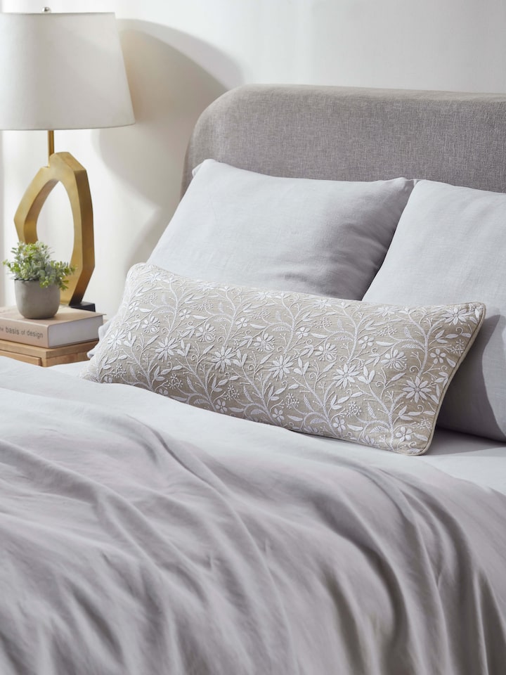 Close-up of Rann beige allover cotton Chikankari hand embroidered cushion cover showcasing the detailed hand embroidery and fine cotton fabric.