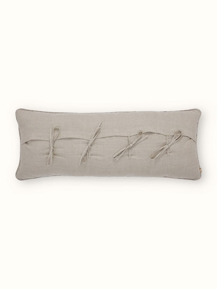 Side view of Rann beige allover cotton Chikankari hand embroidered cushion cover emphasizing the texture and detailed embroidery of the cushion.